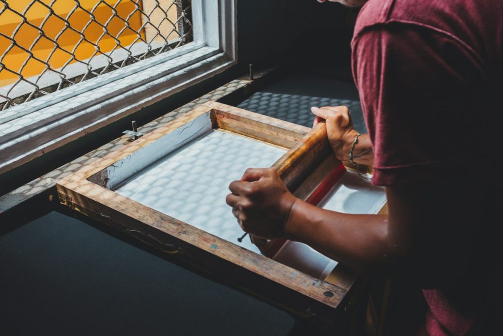 Printer holding a screen-printing frame near a window