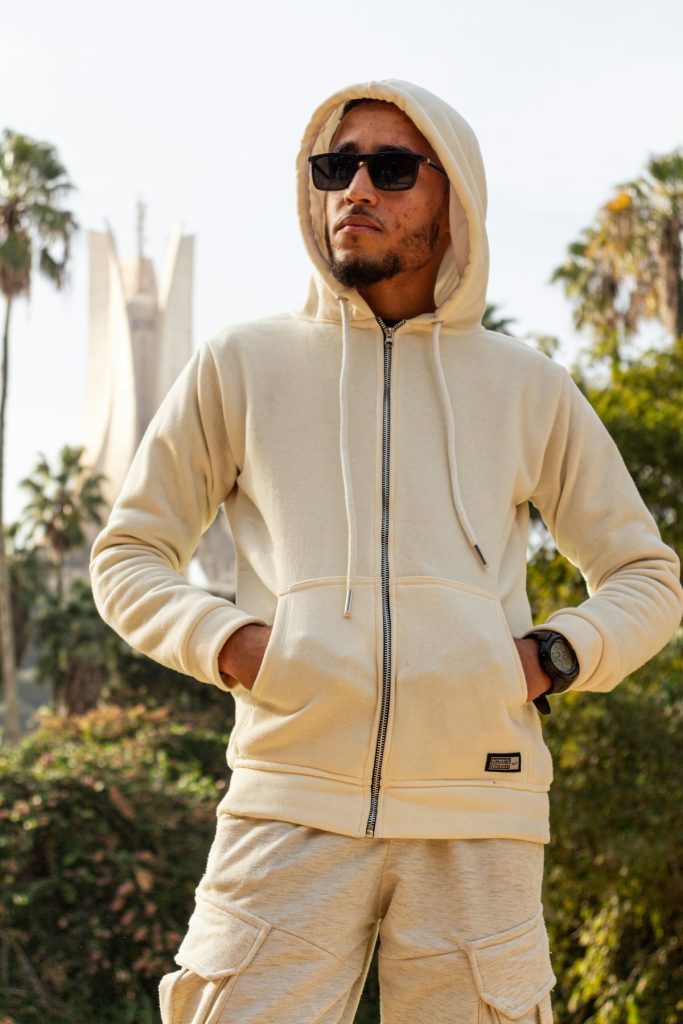 Model in a cream zip-up hoodie