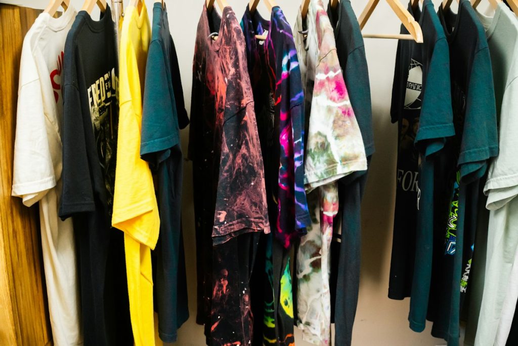 Washed and dyed T-shirts hanging on a rack